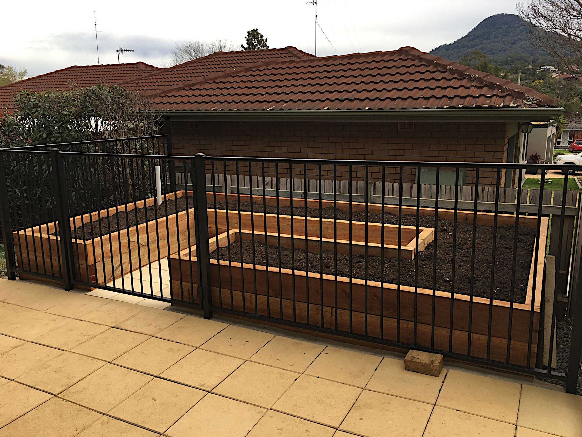 Treated pine raised vegetable garden filled with compost and mushroom compost with internal paving Figtree Wollongong NSW